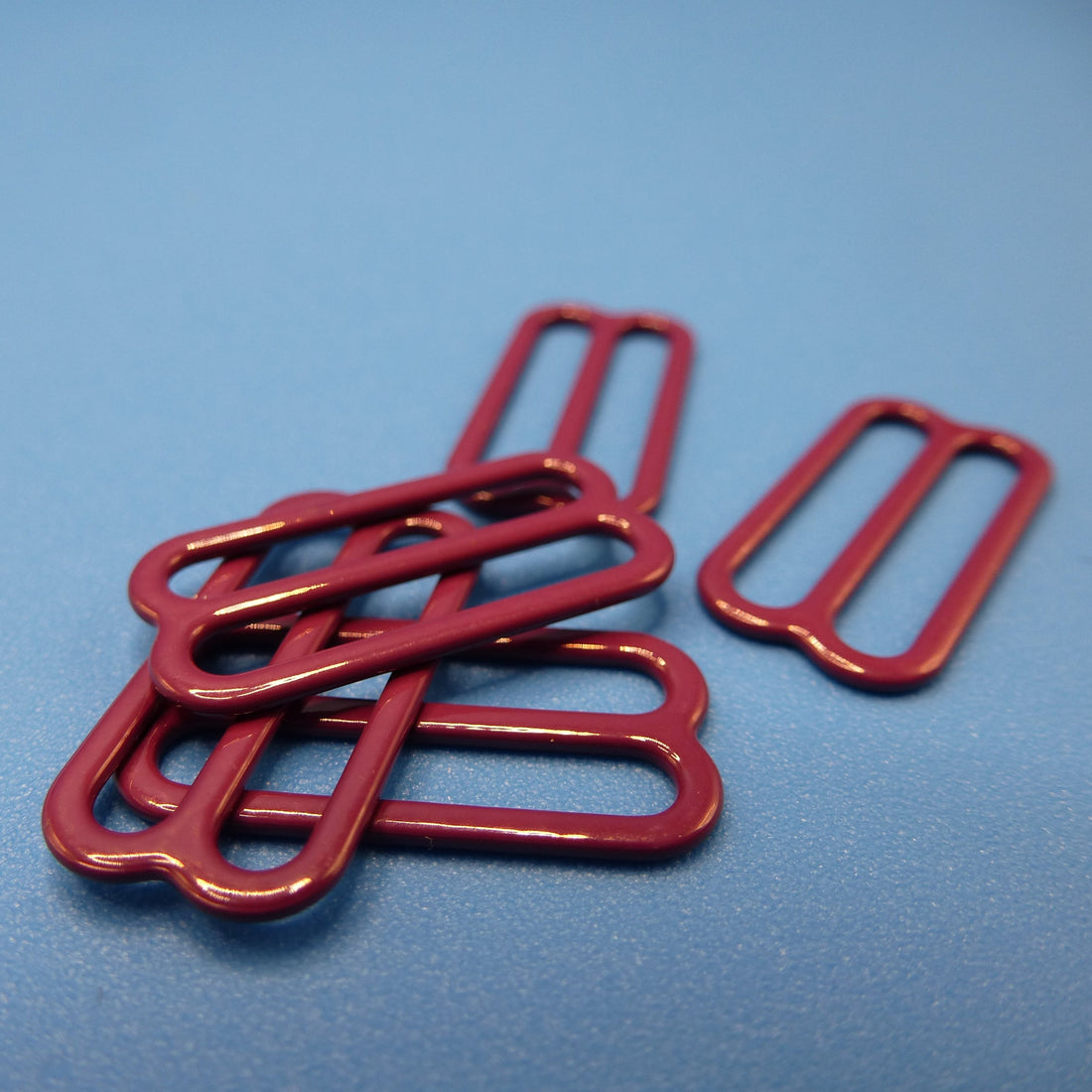 Amaranth purple metal buckles on a blue background